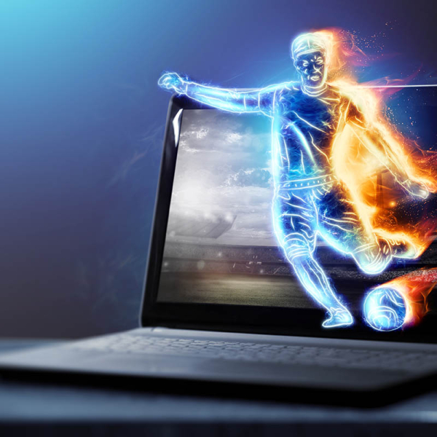 A hologram of a soccer player running out of a notebook, laptop screen. The concept of sports betting, football, gambling, online broadcast of football